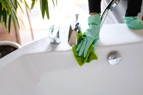 Scrubbing a bathtub during a deep clean in Tucson